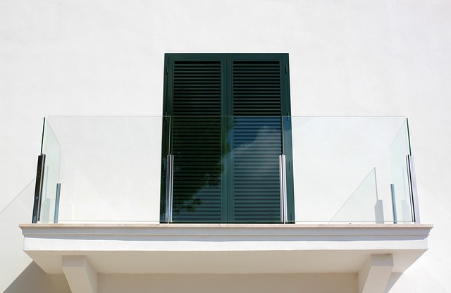 Balkón so skleneným zábradlím a tmavými balkónovými dvermi